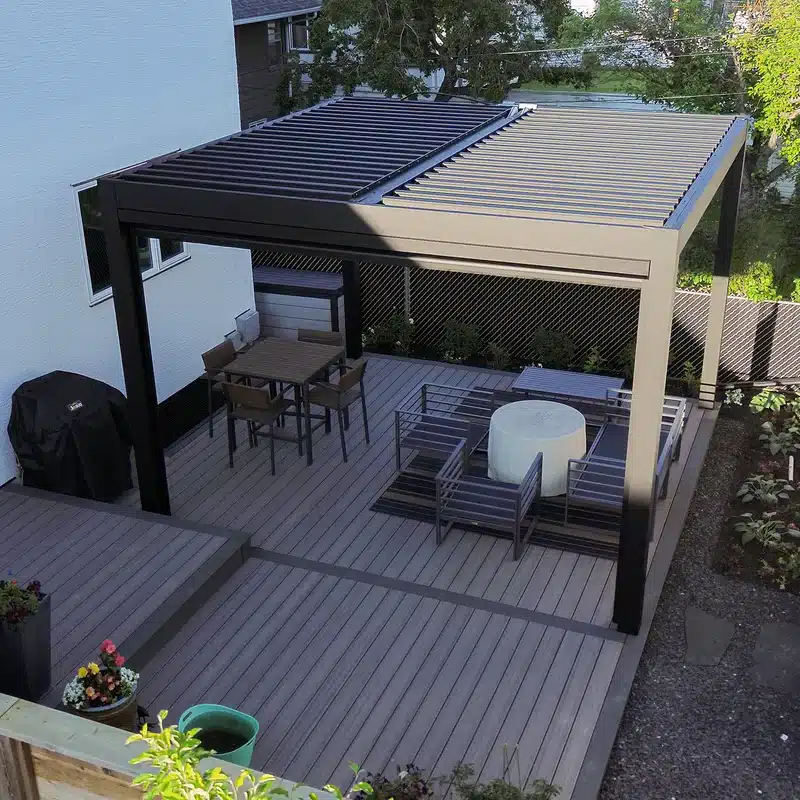 A square aluminum pavilion in an Ottawa backyard shown from above, featuring a full outdoor dining setup beneath.